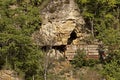 Panorama with high vertical limestone rocks and niches, ruins of former rock monastery